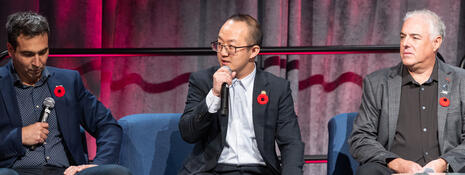 A panel discusses on stage